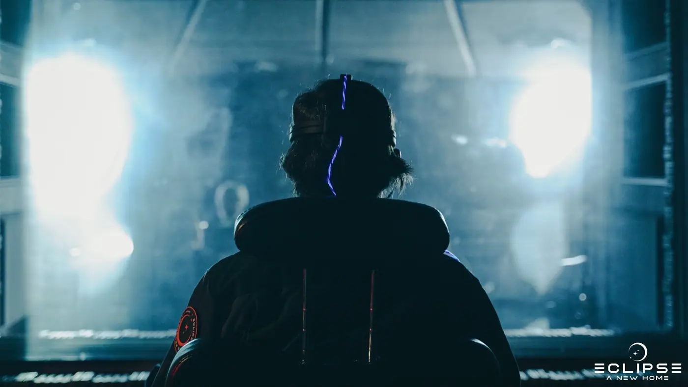 A figure backlit in the smoke of the hangar