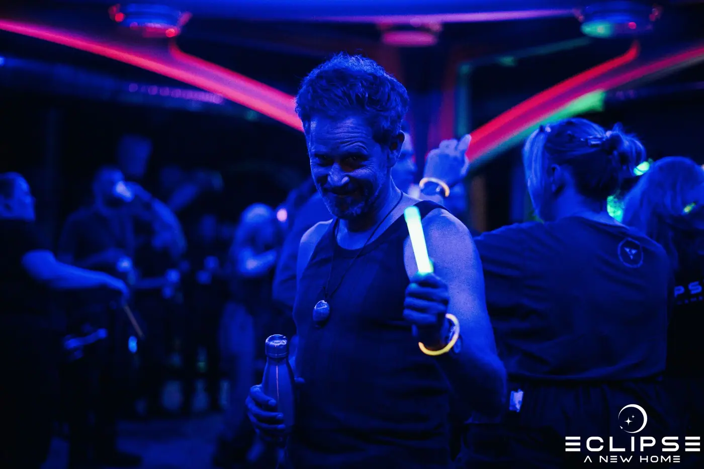Crew members in blue light during a night scene