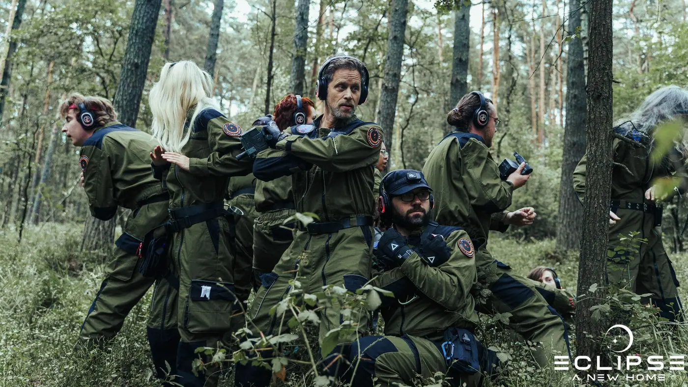 An away team moving through forest in uniform