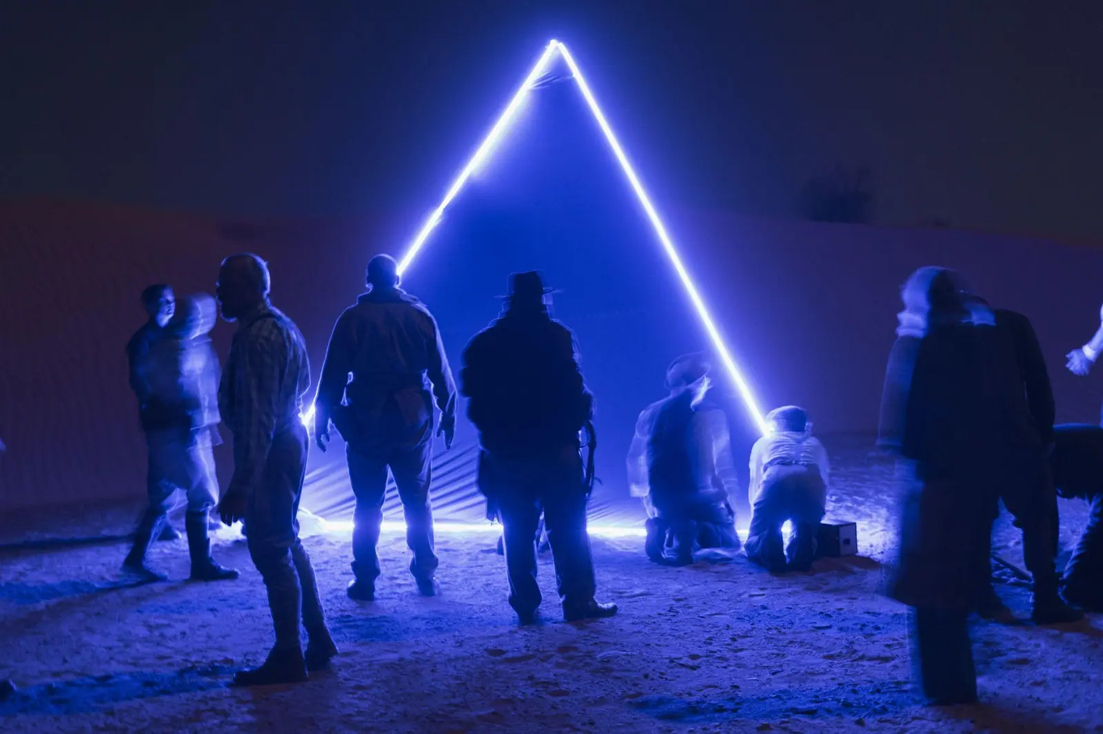 Players gathered under a blue neon gate on the Eclipse set