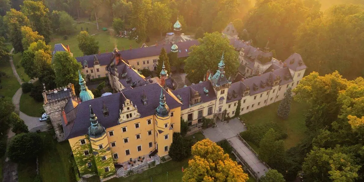 Kliczków Castle from the air at golden hour