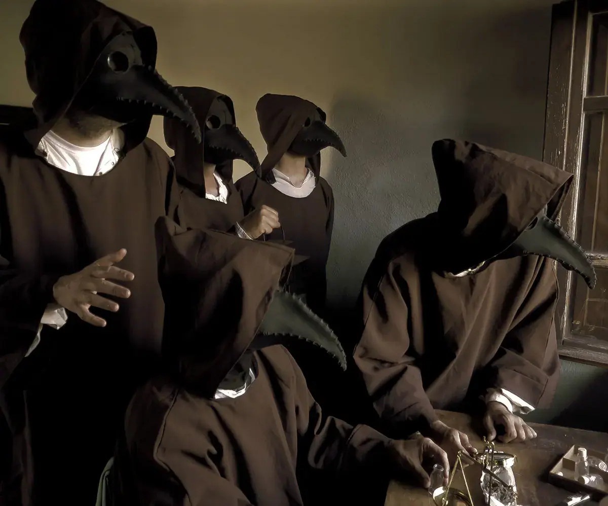 Plague doctors gathered in a stone room