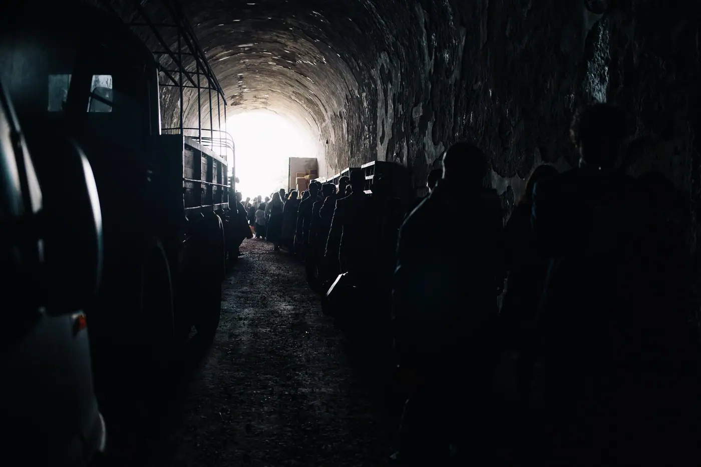 A dark vaulted hall lit from one end