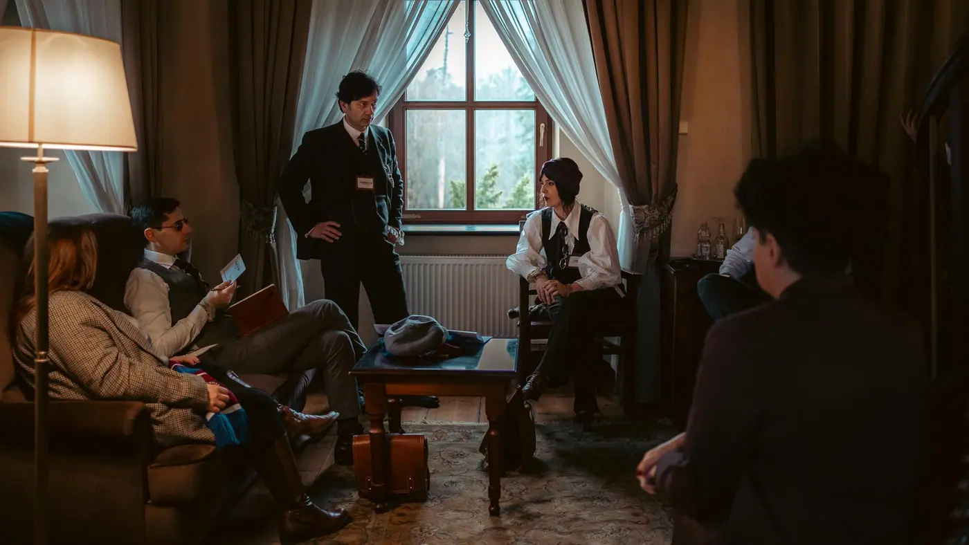 A tense scene around a table in a period interior