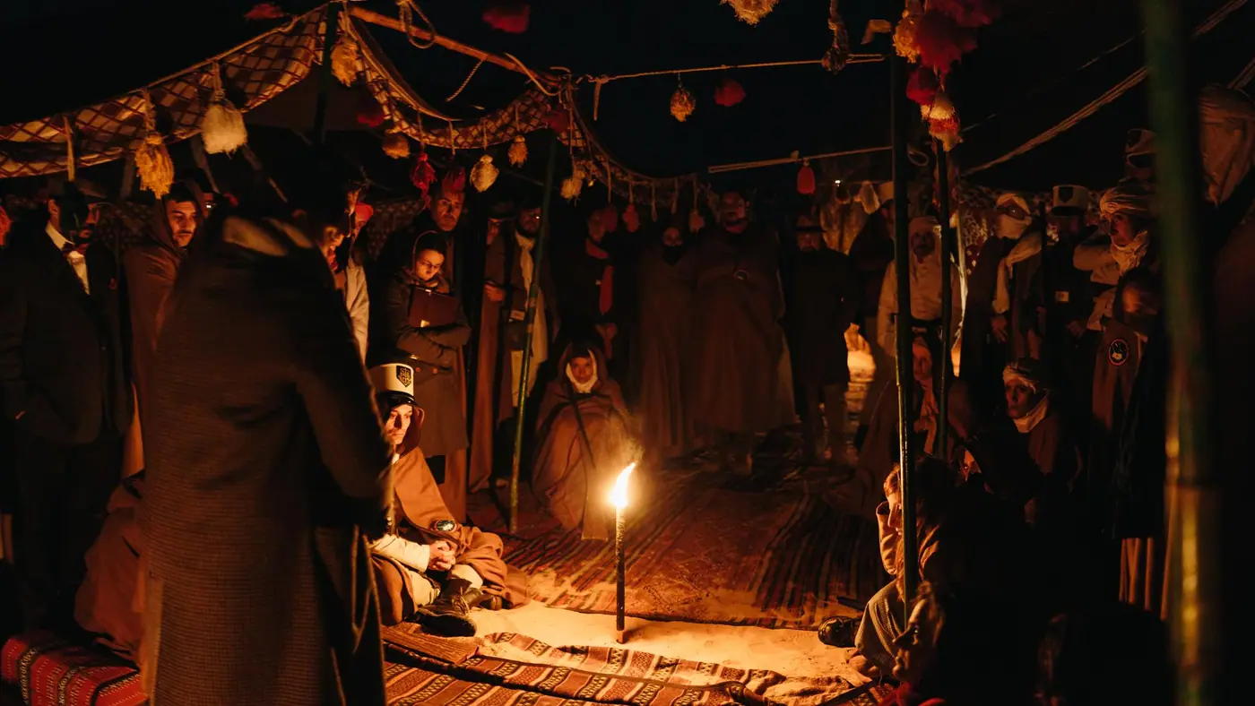 The expedition camp lit by lanterns at night