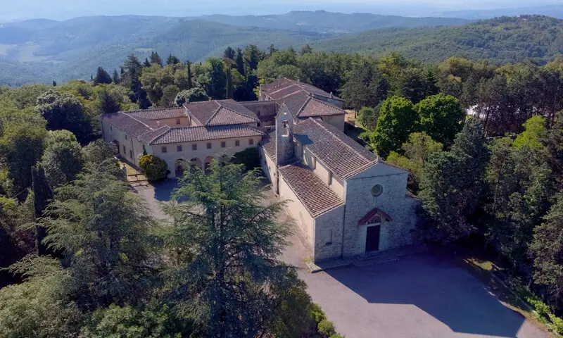 The Convento dell'Incontro seen from above, surrounded by forest