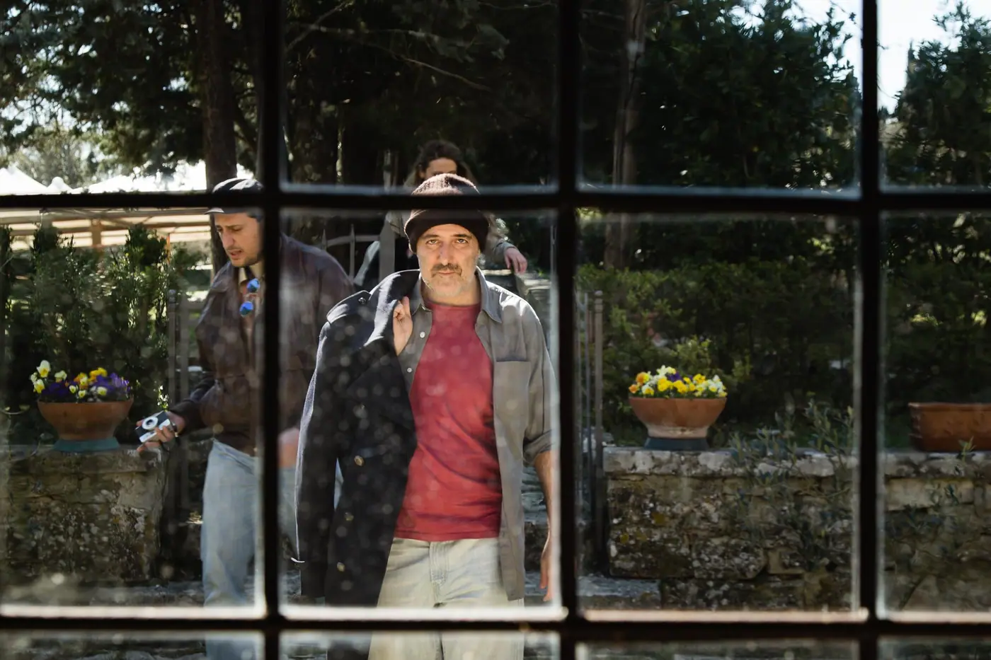 A participant standing behind a glass wall