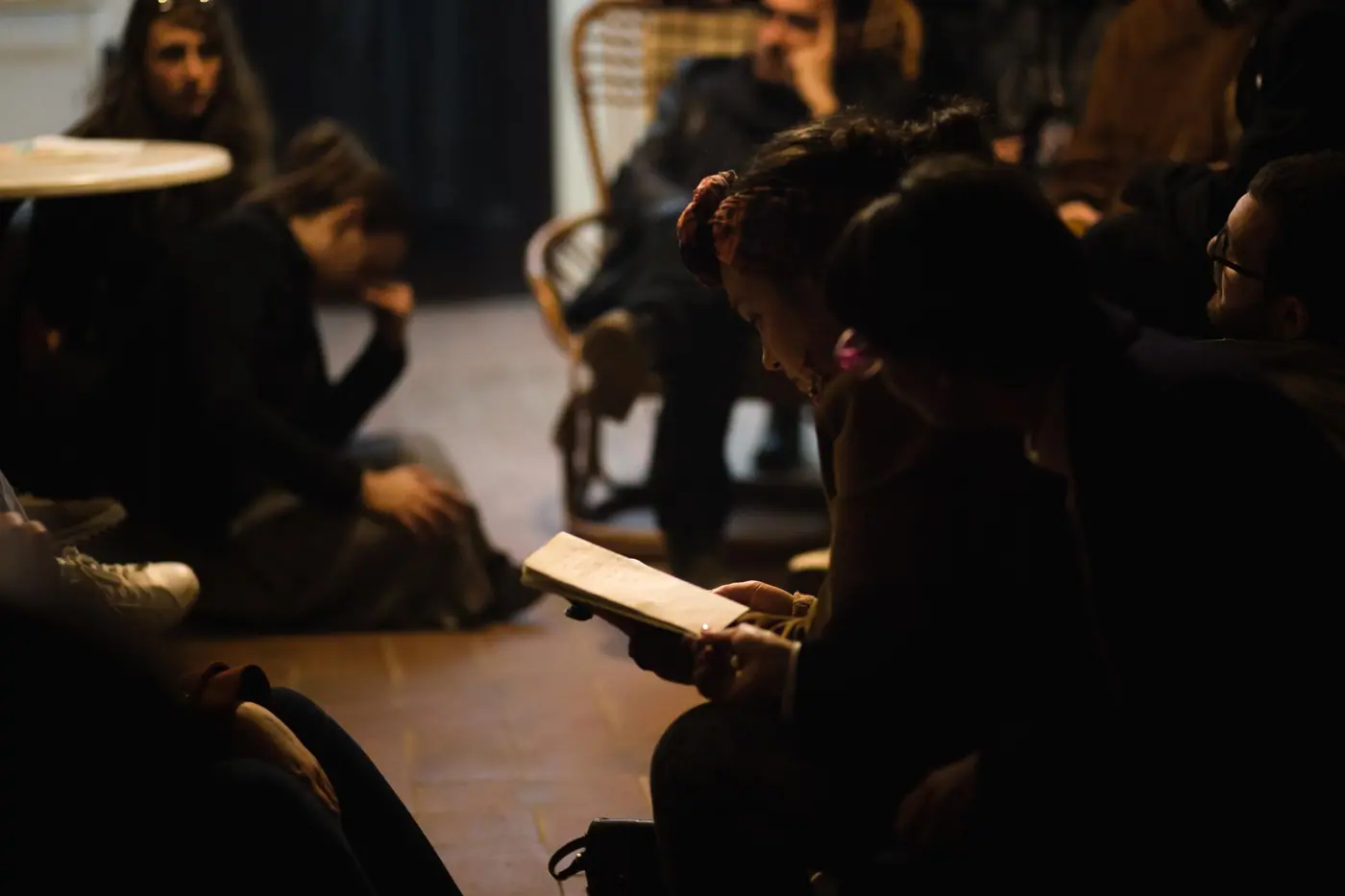 Players around a table in a warmly lit room