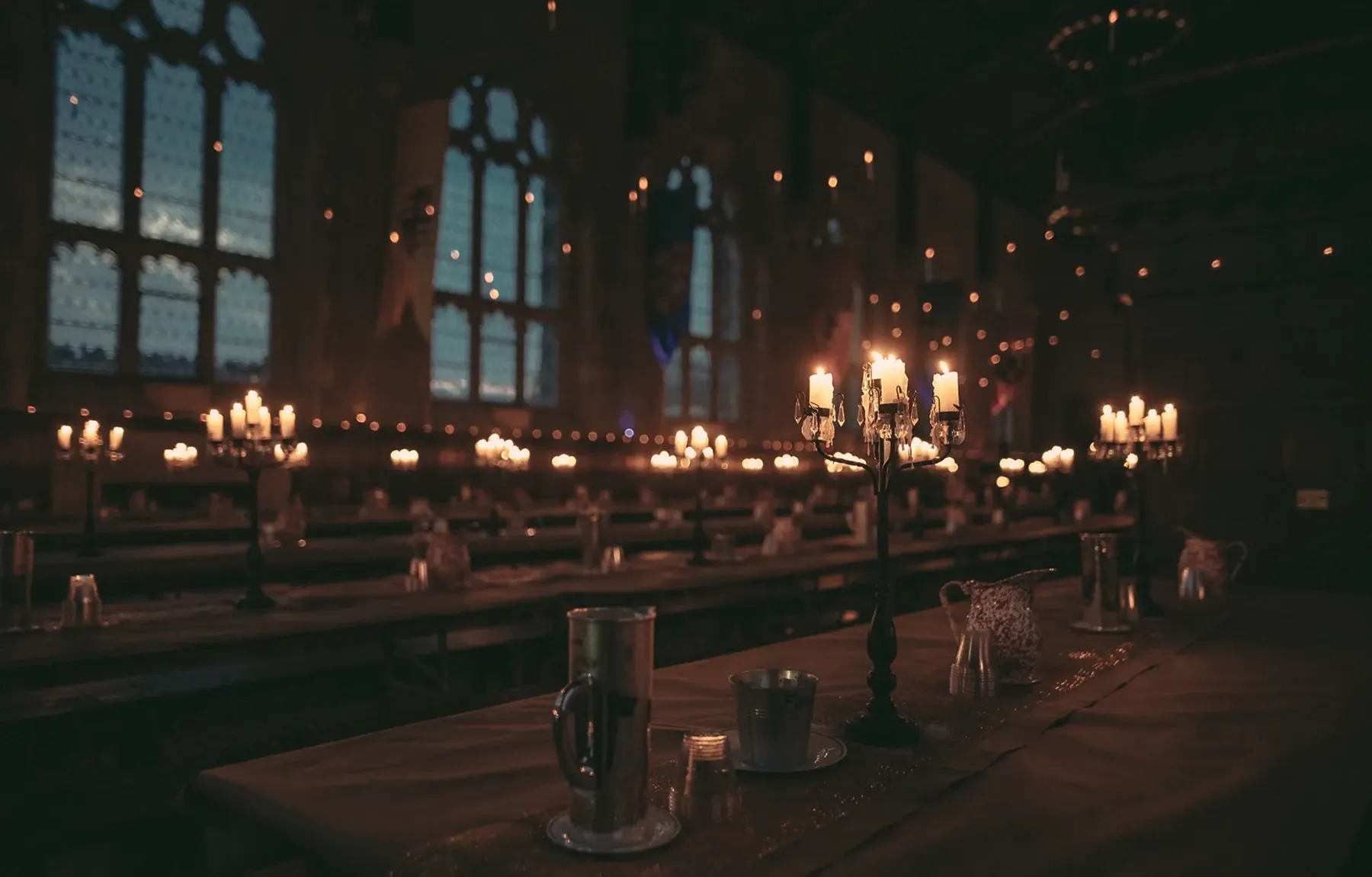 Dining hall lit by candles at night