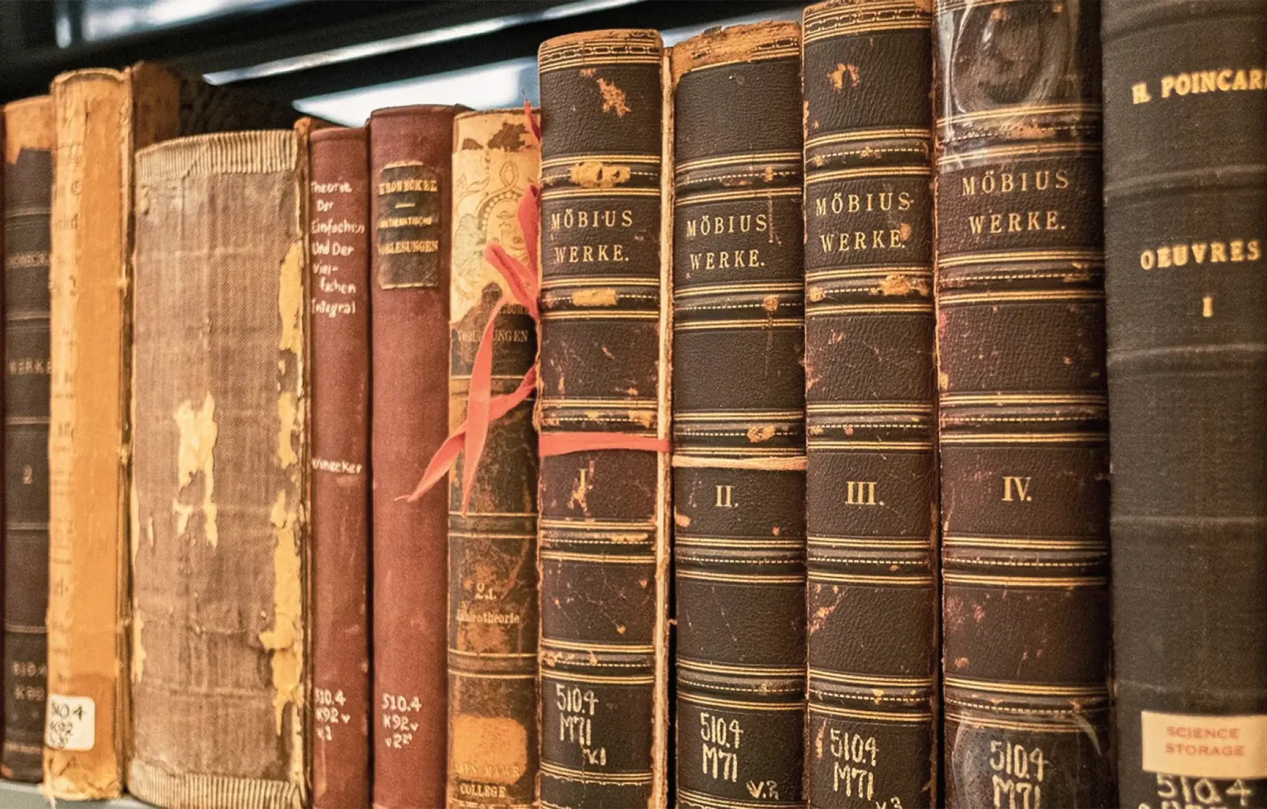 Rows of antique leather-bound books