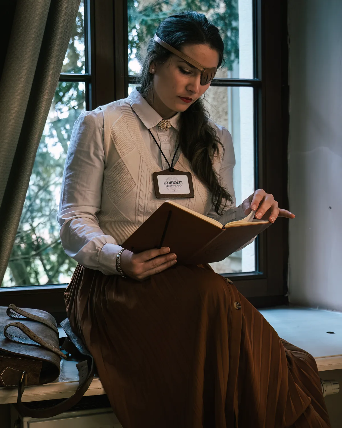 A student reads on a window seat in the daylight